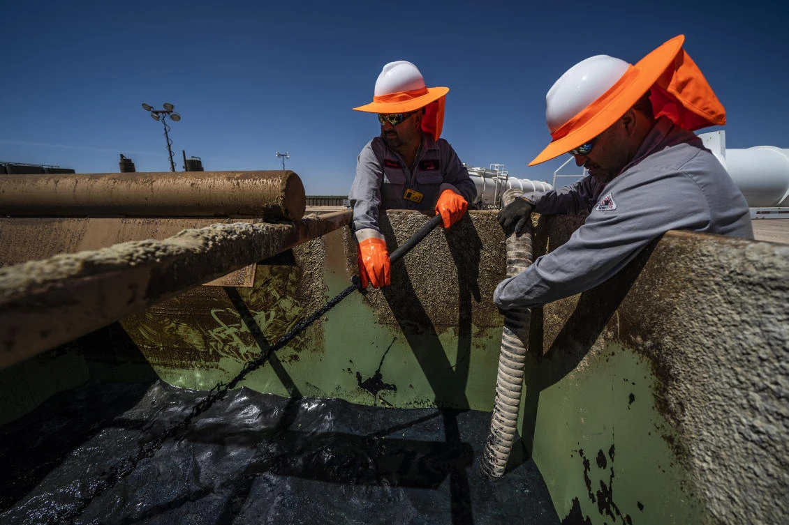 Workers extract oil from wells in the Permian Basin in Midland, Texas. West Texas Intermediate crude dipped 25 cents per barrel on Tuesday, while Brent crude futures were down 51 cents to $61.72 per barrel. (Getty Images)