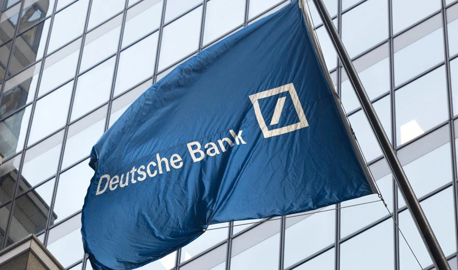 A flag for Deutsche Bank flies outside the German bank's New York offices on Wall Street. (AP Photo/Mark Lennihan, File)