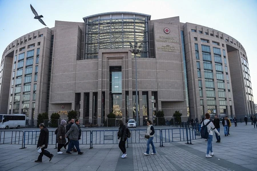 People walk by Istanbul's courthouse on March 26, 2019, during the trial of a US consulate staffer accused of spying and attempting to overthrow the government. (AFP)