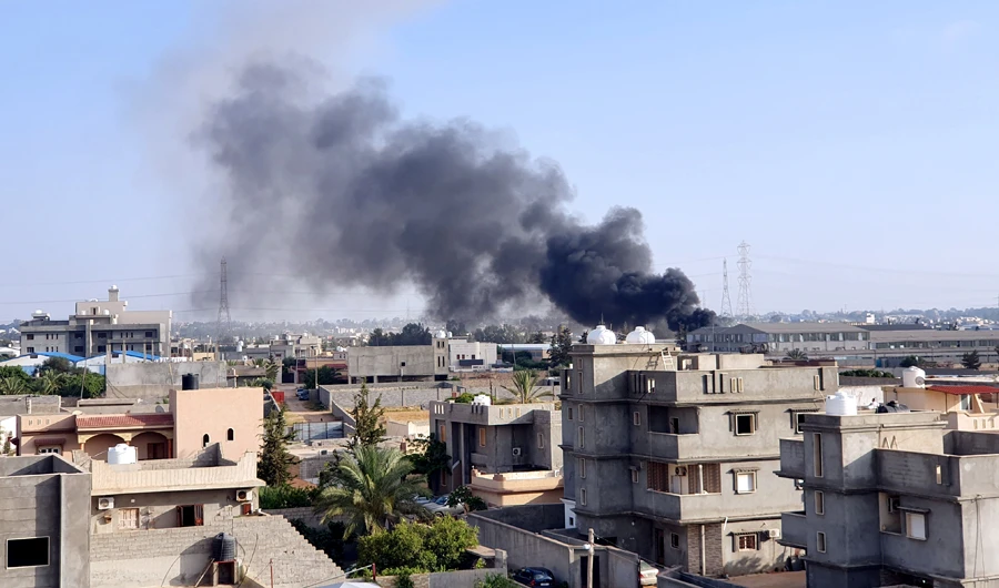 Smoke billows following a reported airstrike by forces loyal to retired Gen. Khalifa Haftar on Tajoura, south of Tripoli, on June 18, 2019. (AFP)