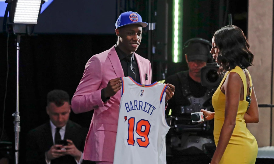 Duke's RJ Barrett shows off a jersey after being selected as the third pick overall by the New York Knicks during the NBA basketball draft on June 20, 2019, in New York. (AP Photo/Julio Cortez)