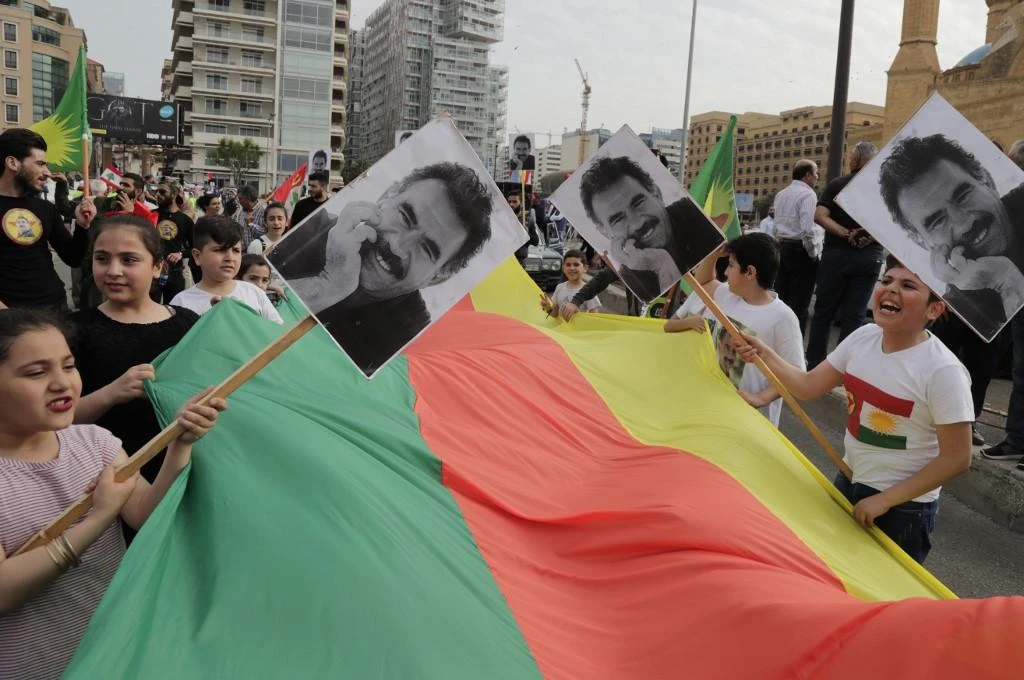 Supporters of Kurdistan Workers’ Party carry national flags and pictures of PKK’s jailed leader Abdullah Ocalan during a demonstration to mark May Day in Beirut. (AFP)
