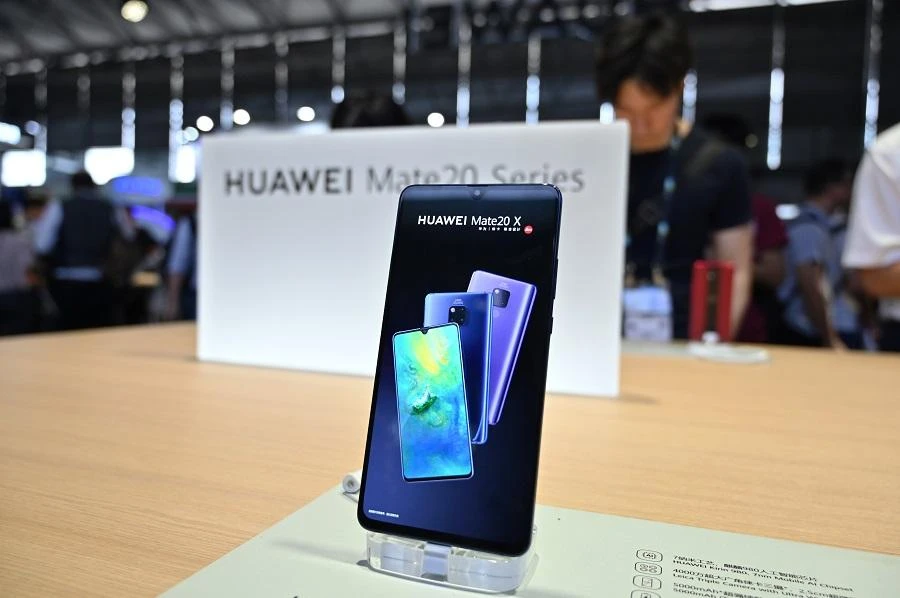 People look at the new Huawei smartphones at the company stand during the Consumer Electronics Show, Ces Asia 2019 in Shanghai on June 11, 2019. (AFP)