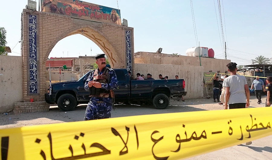 Security forces gather at the site of an attack in Baghdad, Iraq. (AP)