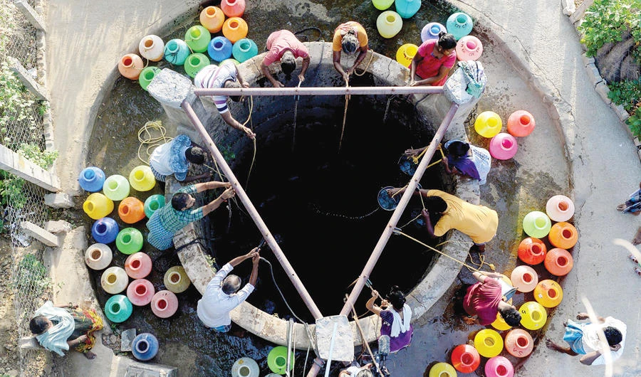 People get water from a community well in Chennai, southern India. (AFP)