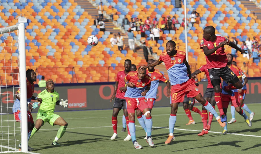 Uganda's Patrick Henry Kaddu, right, heads the ball to scores his side's opening goal during the African Cup of Nations group A soccer match between DR Congo and Uganda at Cairo International Stadium in Cairo, Egypt, on June 22, 2019. (AP Photo/Hassan Ammar)