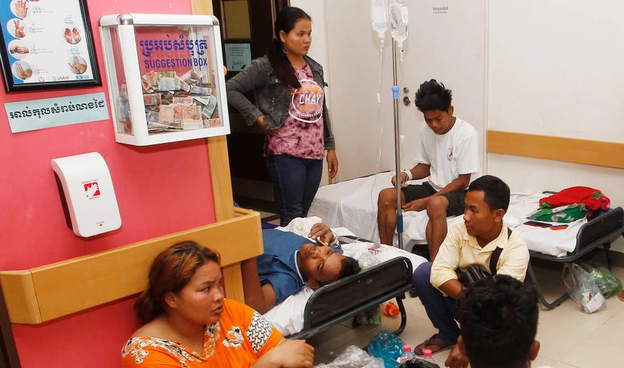 Nhor Chandeun, 31-year-old, center, one of nearly two dozen workers rescued from the rubble of a collapsed building lays on a bed as he talks to a reporter from The Associated Press at a hospital in Preah Sihanouk province, Cambodia, Saturday, June 22, 2019. (AP)