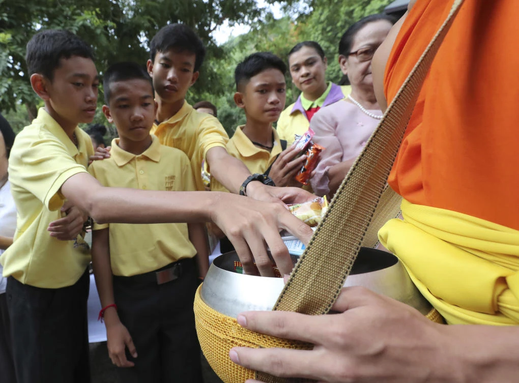 Thai cave boys mark year since ordeal with Buddhist rites