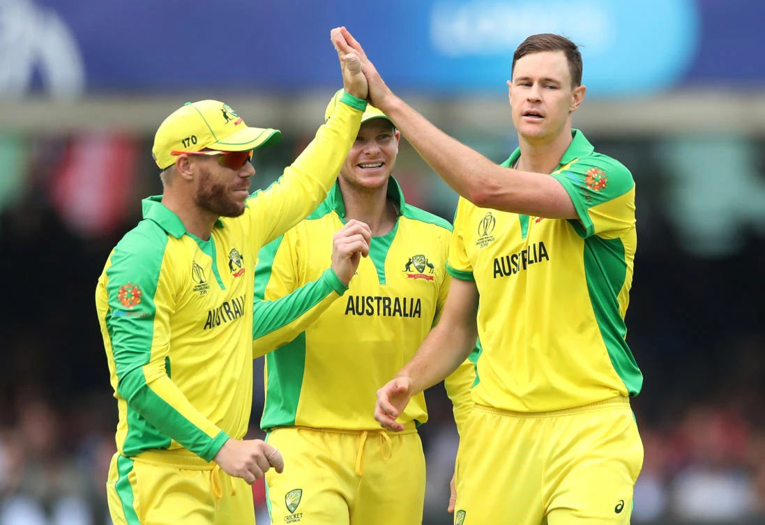 Australia’s Jason Behrendorff, right, David Warner, left, and Steve Smith celebrate taking the wicket of England’s Chris Woakes. (Reuters)