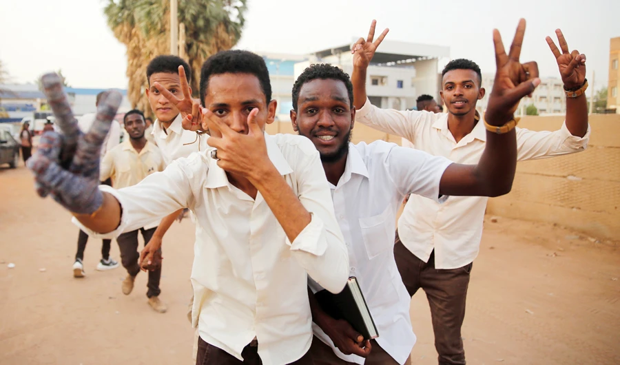 Sudanese protesters flash victory signs during a protest in Khartoum on Monday. (AP)