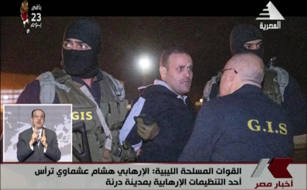 An image grab taken from state-run television station Al-Masriya on May 29, 2019 shows Hisham Al-Ashmawy escorted by members from Egypt’s intelligence service. (AFP)
