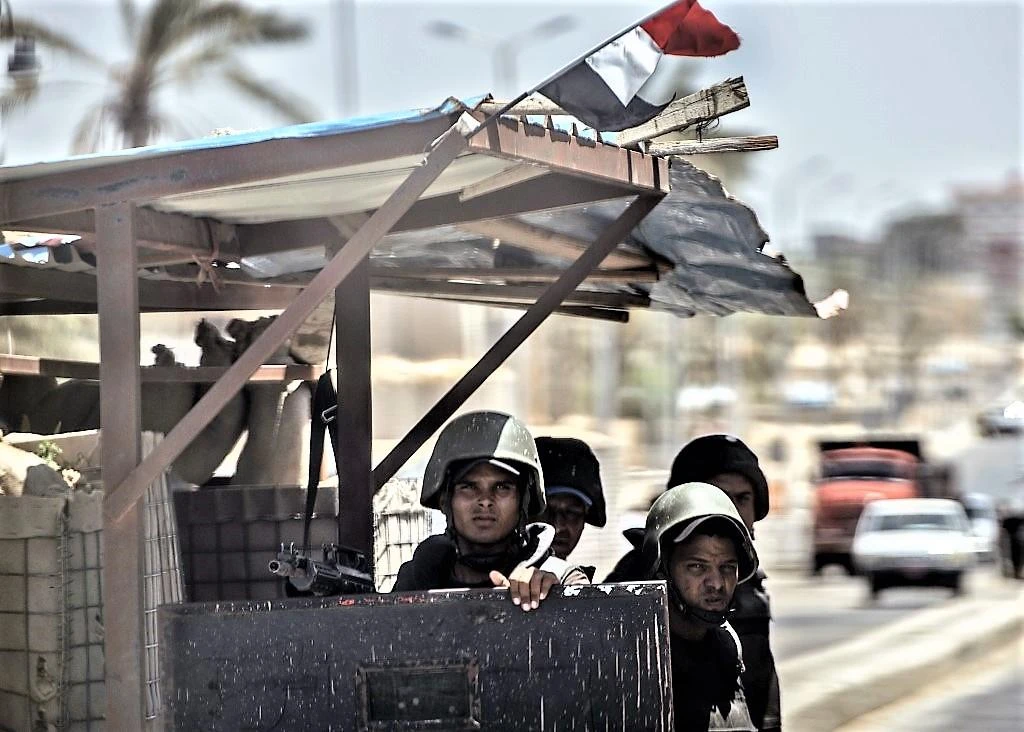 Above, Egyptian security forces guard a checkpoint on a road leading to Arish in this July 26, 2018 photo. Egypt has been battling Islamist militants in the Sinai Peninsula for years. (AFP)
