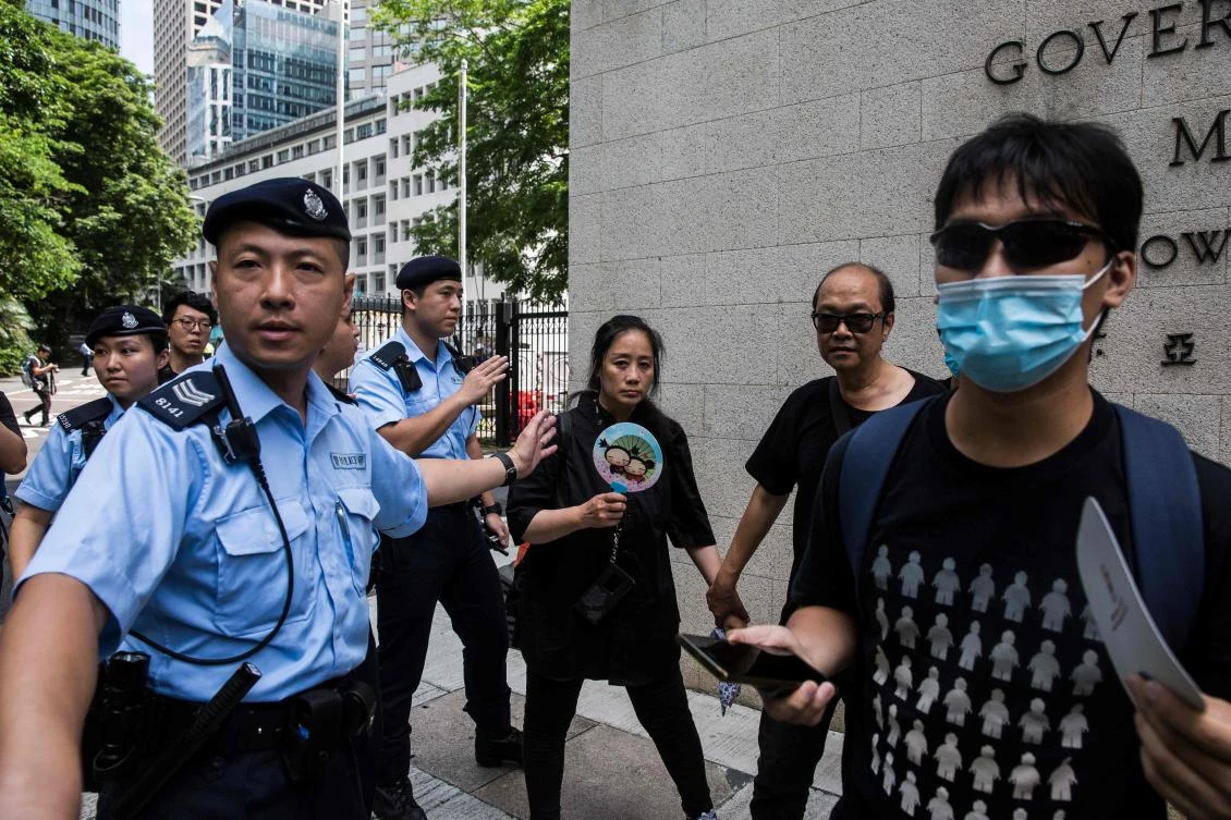 Police escort protesters outside the Central Government Offices during a rally against a controversial extradition bill in Hong Kong on June 27, 2019. (AFP)