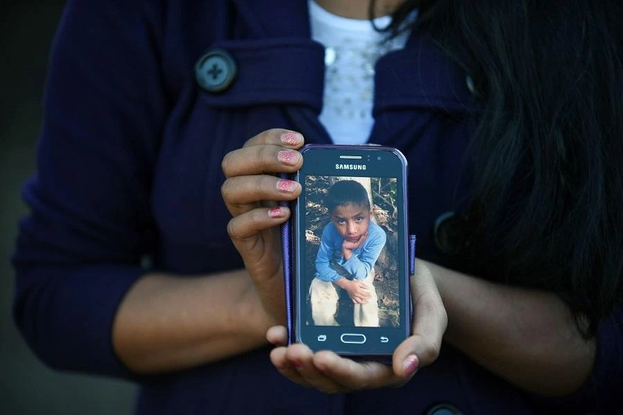 Catarina Gomez Lucas, sister of eight-year-old migrant Felipe Gomez, who died in a medical center in Alamogordo, New Mexico, United States, on December 24, while in custody of US Customs and Border Protection officers, shows a picture of her brother on a mobile phone. (File/AFP)
