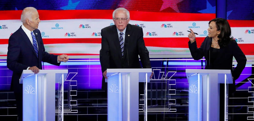 Former Vice President Joe Biden (left) and Senator Kamala Harris (right) debate racial issues as Senator Bernie Sanders listens during the second night of the first US Democratic presidential candidates 2020 election debate in Miami, Florida, on June 27, 2019. (REUTERS/File Photo)