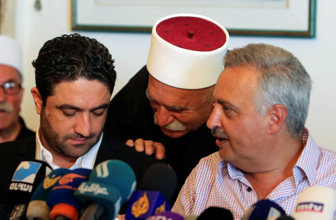Saleh al-Gharib, the state minister for refugee affairs, whose two bodyguards were killed yesterday in what he termed an attempted assassination, sits with Talal Arslan, a Druze politician, during a news conference, in Khaldeh, near Beirut, Lebanon July 1, 2019. (Reuters)