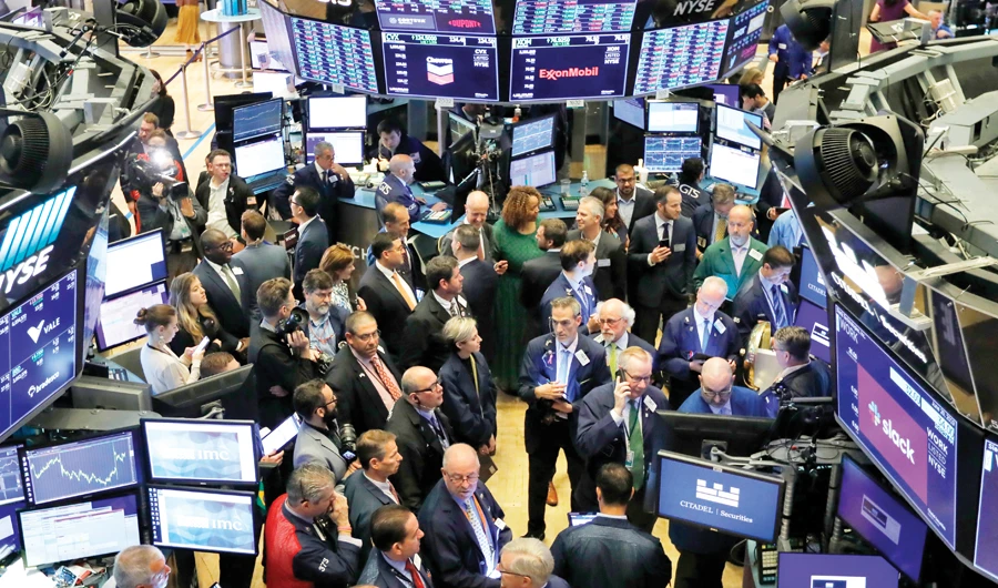 Traders gather at the New York Stock Exchange. US stocks on Monday were solidly higher, with the DJIA index gaining 250 points at the opening bell. (AP/File)