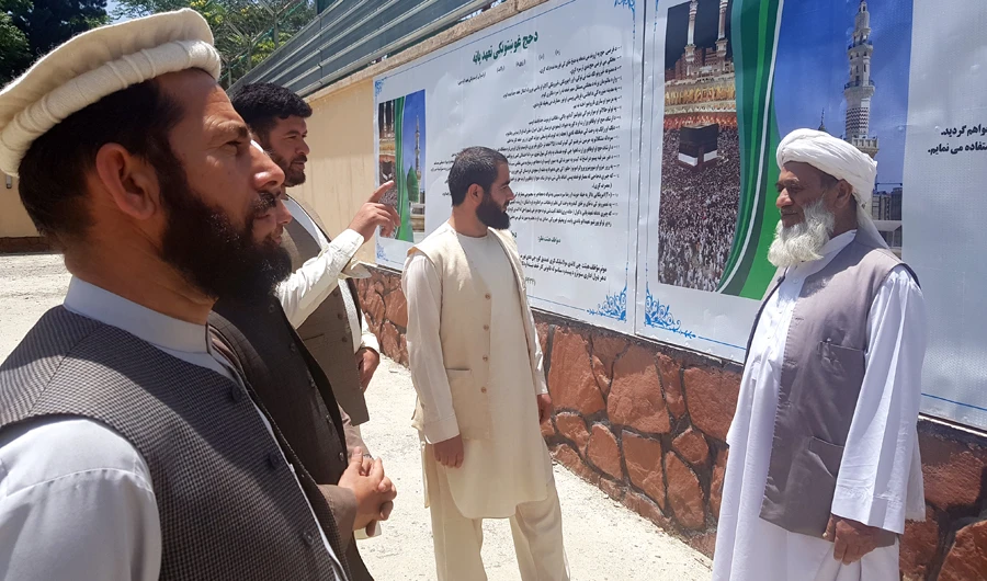 Afghan government officials discuss Hajj preparations at the yard of a center for Hajjis in Kabul on Sunday. This year 30,000 Afghan are set to perform Hajj. (AN photo)
