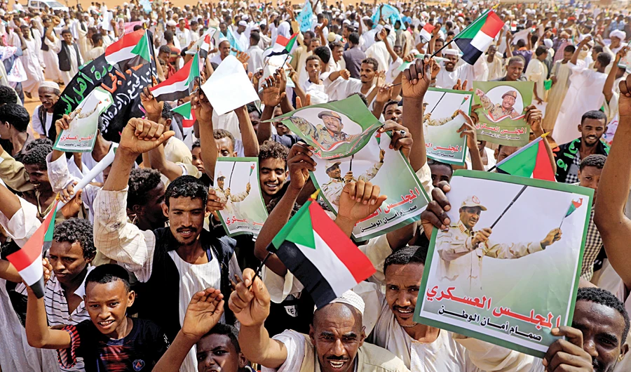 Supporters of Lt. Gen. Mohamed Hamdan Dagalo, deputy head of the military council, cheer at a meeting in Aprag village, 60 km from Khartoum. (Reuters)