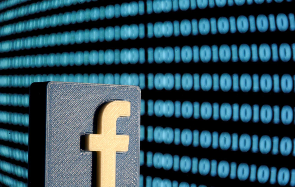 A 3-D printed Facebook logo is seen in front of displayed binary code in this illustration picture, June 18, 2019. (REUTERS/Dado Ruvic/Illustration/File Photo)