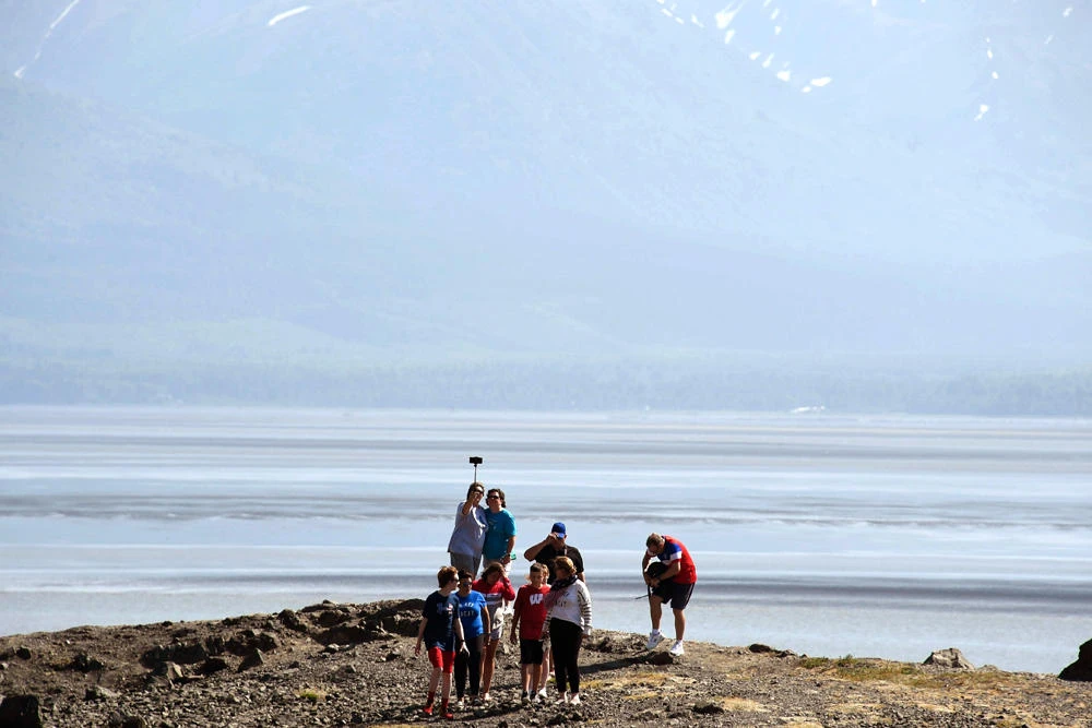 People visit a rock outpost at Beluga Point along the Turnagain Arm on July 4, 2019 south of Anchorage, Alaska. Alaska is bracing for record warm temperatures and dry conditions in parts of the state. (Lance King/Getty Images/AFP)