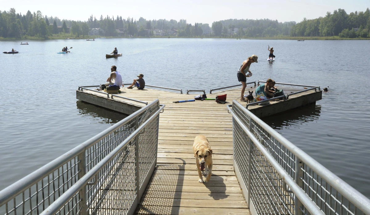 People swarm to DeLong Lake hoping to stay cool in the record breaking heat in Anchorage, Alaska on Friday, July 5, 2019. (Anchorage Daily News via AP)