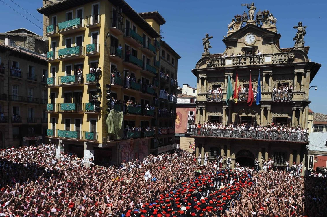 Revelers celebrate as the ‘Pamplonesa’ municipal music band performs during the ‘Chupinazo’ (start rocket) to mark the kickoff at noon sharp of the San Fermin Festival in Pamplona, northern Spain, on July 6, 2019. (AFP)