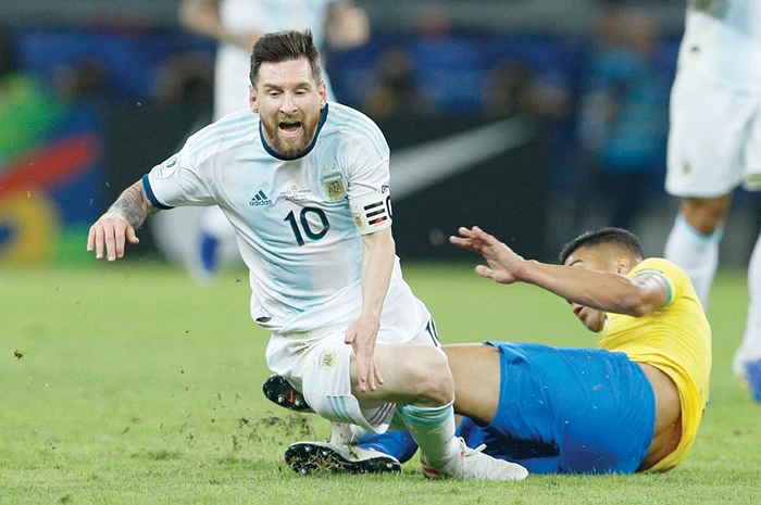 Argentina’s Lionel Messi is tackled by Brazil’s Casemiro during a Copa America semifinal soccer match in Belo Horizonte, Brazil. (AP)