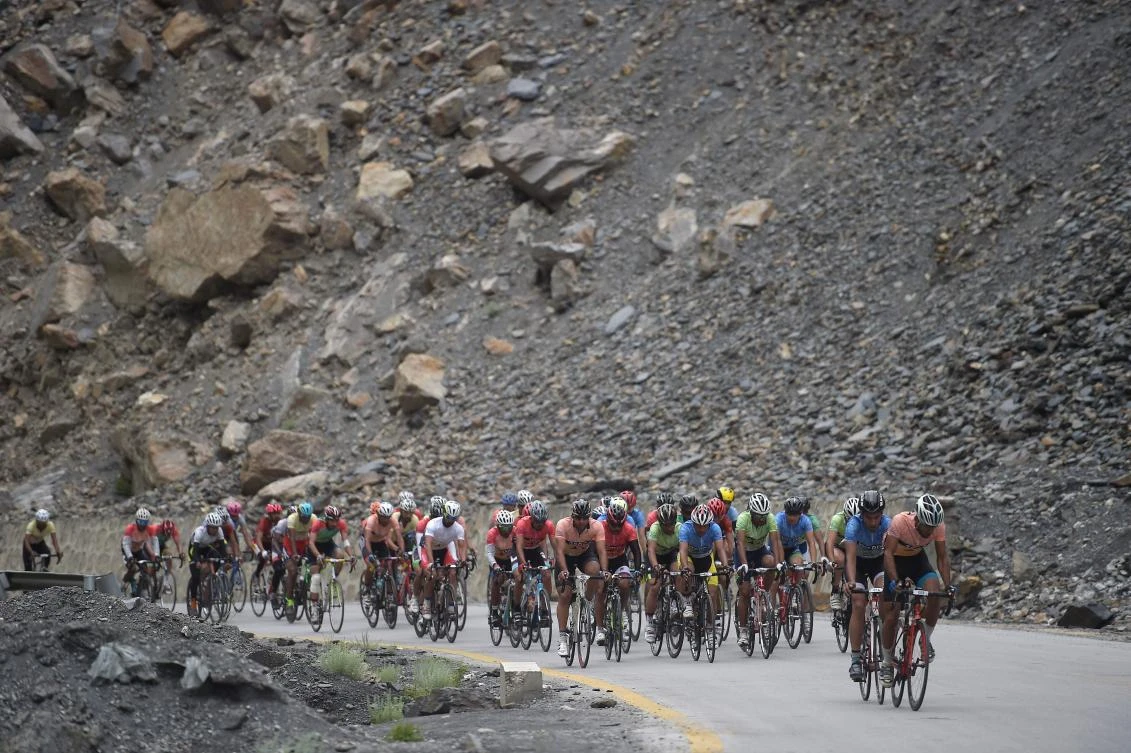 The threat of danger was in stark contrast with the joyful welcome the cyclists received in villages along the route. (AFP)