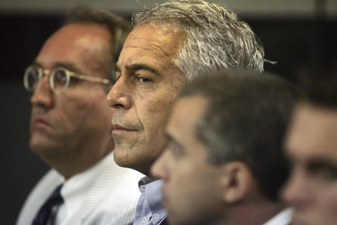 In this July 30, 2008 file photo, Jeffrey Epstein, center, is shown in custody in West Palm Beach, Fla. (AP)