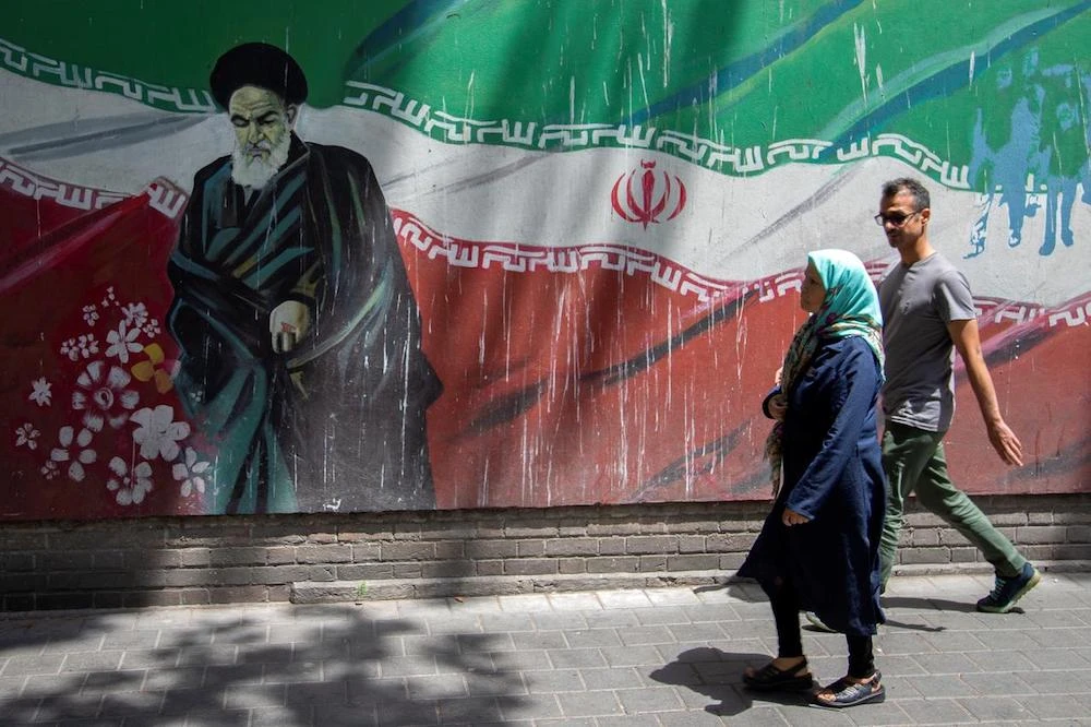 People walk in front of a mural of Iran's late leader Ayatollah Ruhollah Khomeini in Tehran, Iran July 7, 2019. (Reuters)