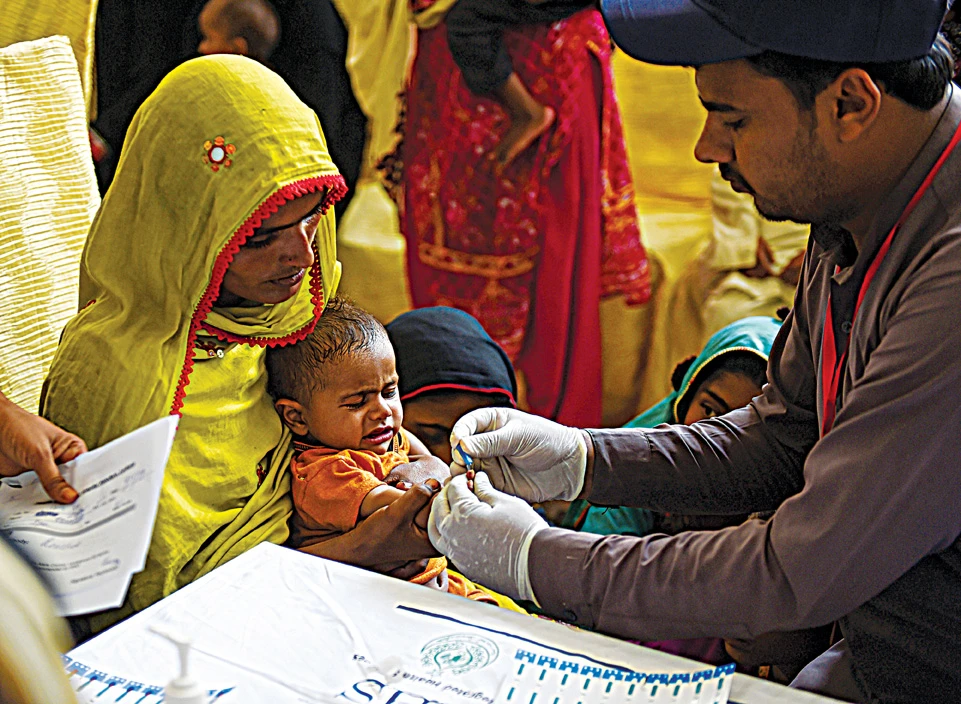 A Pakistani paramedic takes a blood sample from a baby for a HIV test at a state-run hospital in the southern Sindh province. (AFP)
