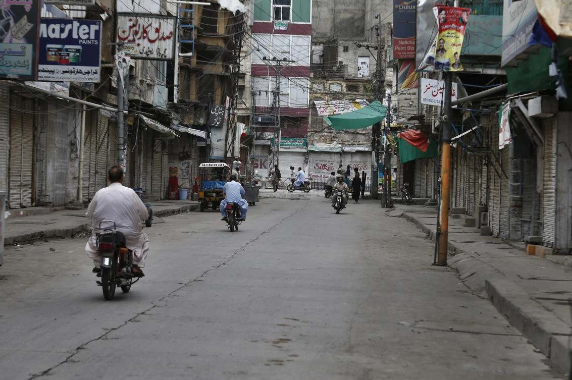 Motorcyclists ride through a market which is closed due to a strike in Rawalpindi, Pakistan, Saturday, July 13, 2019. (AP)