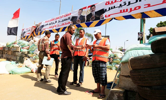 In this July 25, 2013 picture, Muslim Brotherhood supporters hold camp at an enclave in Cairo, Egypt after the military ousted Islamist President Mohammed Morsi. A militant cell linked to the banned group that was suspected to have escaped from Egypt and set up operations in Kuwait. (AP file photo)