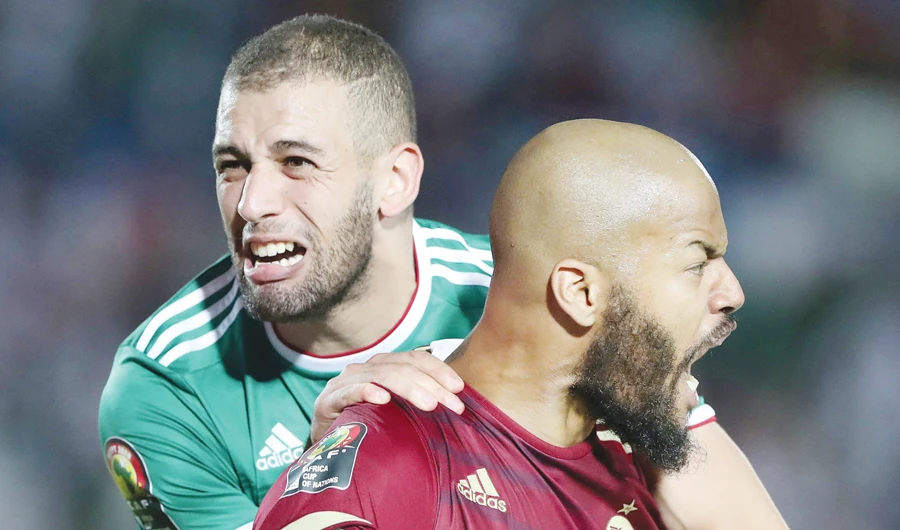 Algeria’s Islam Slimani and Rais M’Bolhi celebrate at Egypt’s Suez Stadium after Thursday’s victory. (Reuters)