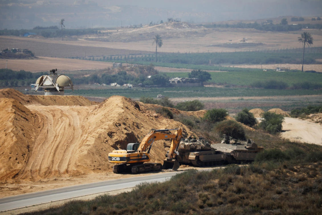 An Israeli military armoured personnel carrier (APC), a tank and a bulldozer are seen next to the border with the Gaza Strip, in southern Israel July 11, 2019. (Reuters)