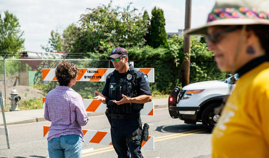Police Officer Sam Lopez turns away would-be protesters in front of a road block near the Northwest Detention Center, Saturday July 13, 2019 in Tacoma, Wash. (AP)