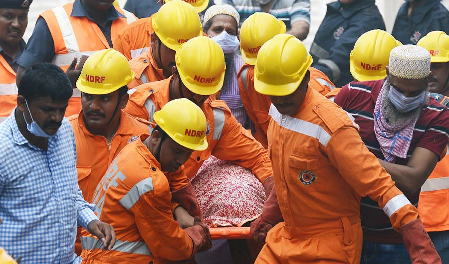 Indian rescue workers carry a victim's body from the building collapse site in Mumbai. (AFP file photo)