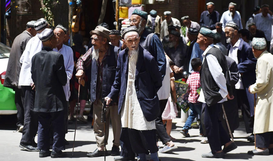 This photo taken on May 31, 2019 shows Uighur men leaving a mosque after prayers in Hotan in China's northwest Xinjiang region. (AFP)