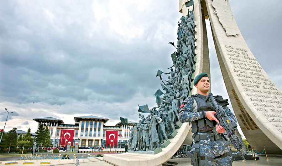 A security officer stands near the ‘Martyrs Monument’ outside the presidential palace in Ankara on Monday. (AP)