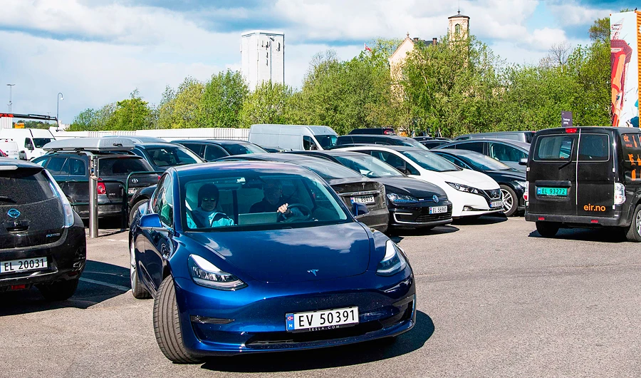 A man drives his electric car from Tesla Motors as he leaves an all-electric cars parking lot in Oslo on May 3, 2019. (AFP)