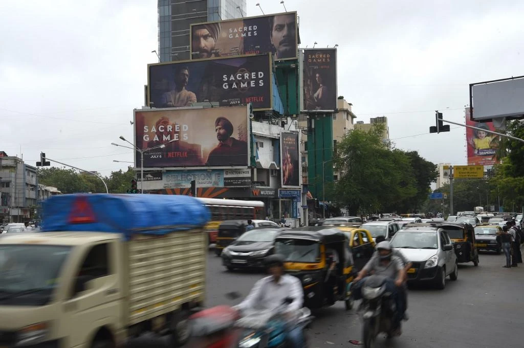 Commuters travel past billboards for Sacred Games, Netflix’s first original Indian series, in this July 4, 2018 photo. India is among the last big growth markets for the company. (AFP)