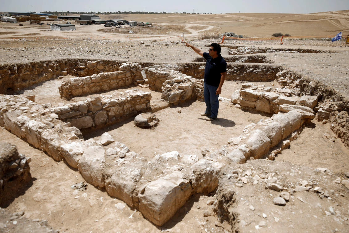 An archaeologist gestures as he stands inside the remains of a mosque discovered by the Israel Antiquities Authority and which they say is one of the world's oldest mosques, in the outskirts of the Bedouin town of Rahat in southern Israel July 18, 2019. (Reuters)