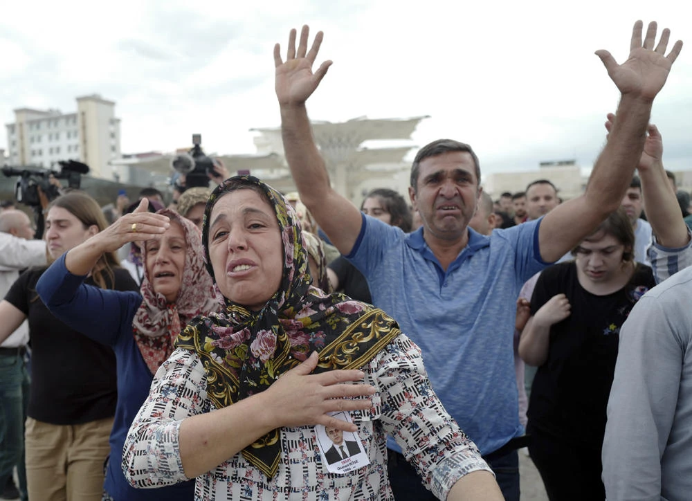 Family members of Osman Kose, a Turkish diplomat killed in Iraq, react during his funeral prayers in Ankara, Turkey, on July 18, 2019. (AP Photo/Burhan Ozbilici)