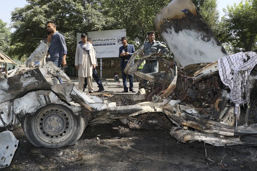 Security personnel investigate the site of a bomb explosion in front of Kabul University in Kabul on Friday, July 19, 2019. (AFP)