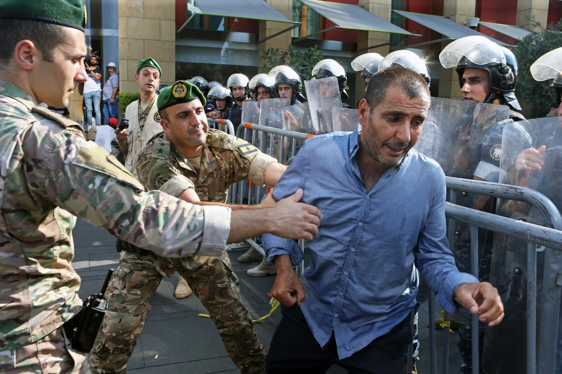Retired Lebanese soldiers in tense standoff with army during benefit cuts protest