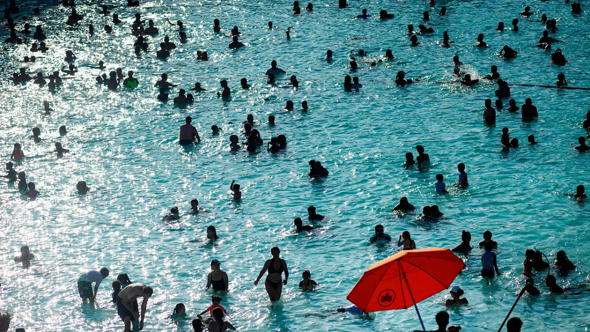 People enjoy the Astoria Pool on a hot afternoon in the borough of Queens, New York City, on July 20, 2019. (AFP)