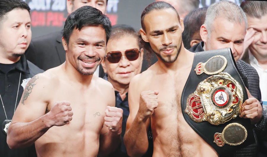 Manny Pacquiao and Keith Thurman pose in Las Vegas during a weigh-in on Friday. (AP)