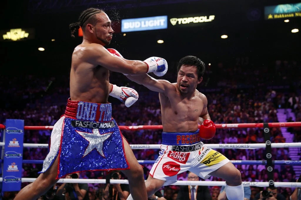Manny Pacquiao, right, connects with a punch on Keith Thurman during their WBA welterweight title fight on Sunday, July 20, 2019 in Las Vegas, Nevada. (Getty Images/AFP)