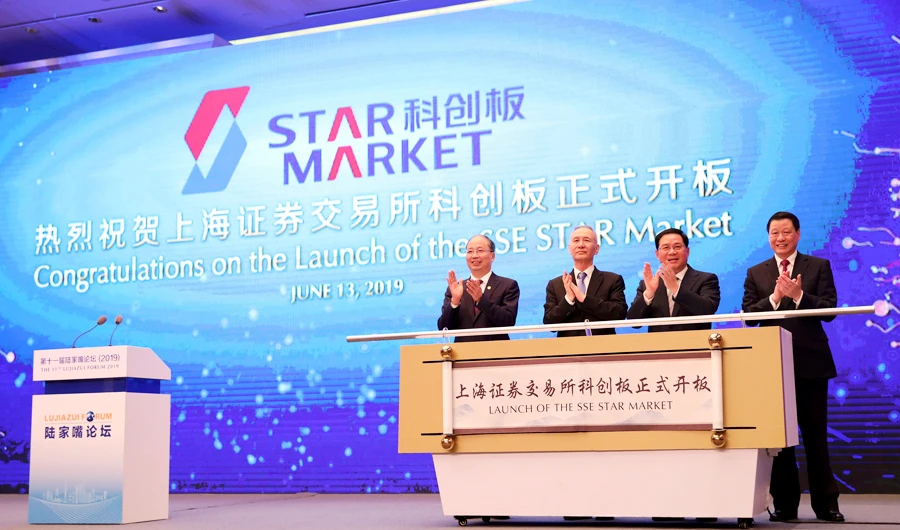 In this June 13, 2019, photo released by Xinhua News Agency, guests, from left, Yi Huiman, chairman of China Securities Regulatory Commission, Liu He, vice premier, Li Qiang, top party official of Shanghai, and Ying Yong, Shanghai's mayor, celebrate the launch of the SSE STAR Market, previously referred to as the Shanghai science and technology innovation board in Shanghai. (AP)